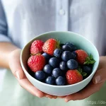 노화를 억제하는 항산화 식품 - **Prompt:** A close-up portrait of a radiant woman in her late 30s, with clear, dewy skin and a sere...